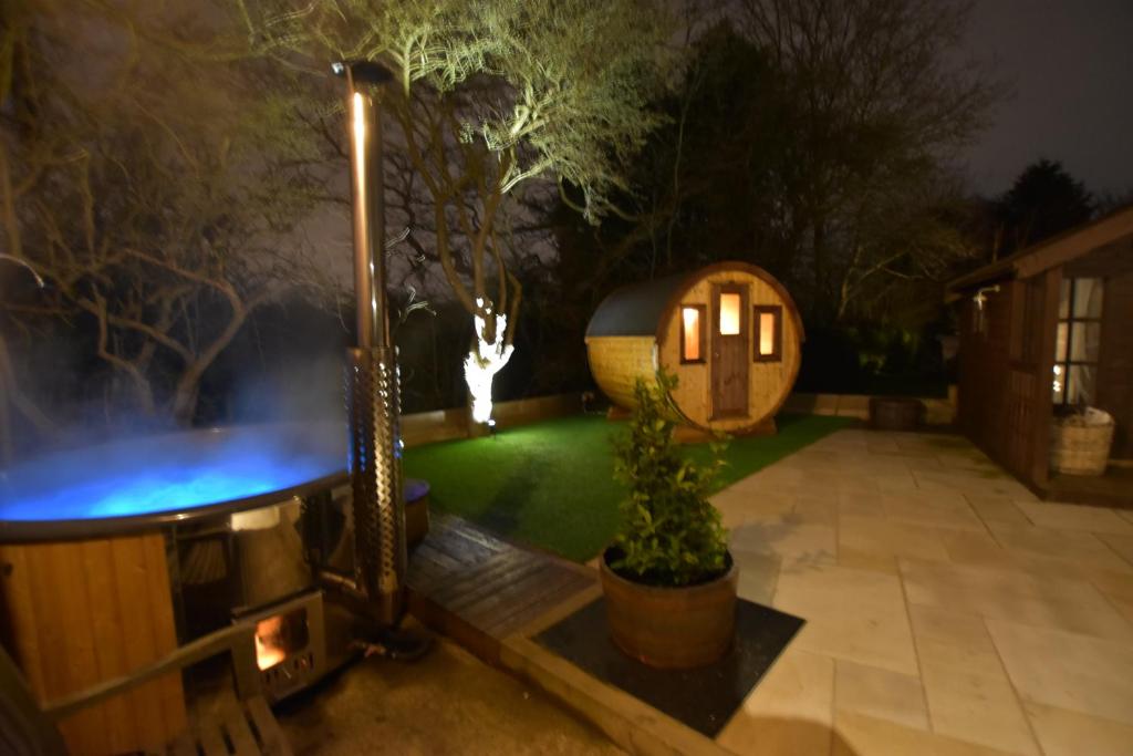 un giardino di notte con una casa hobbit e luci di Oak tree stables cottage a Birmingham