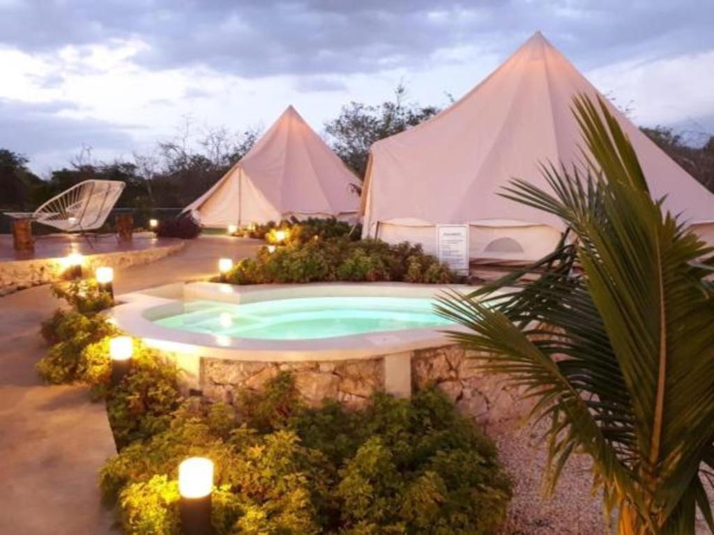 a group of tents with a swimming pool with lights at Hameki in Homún