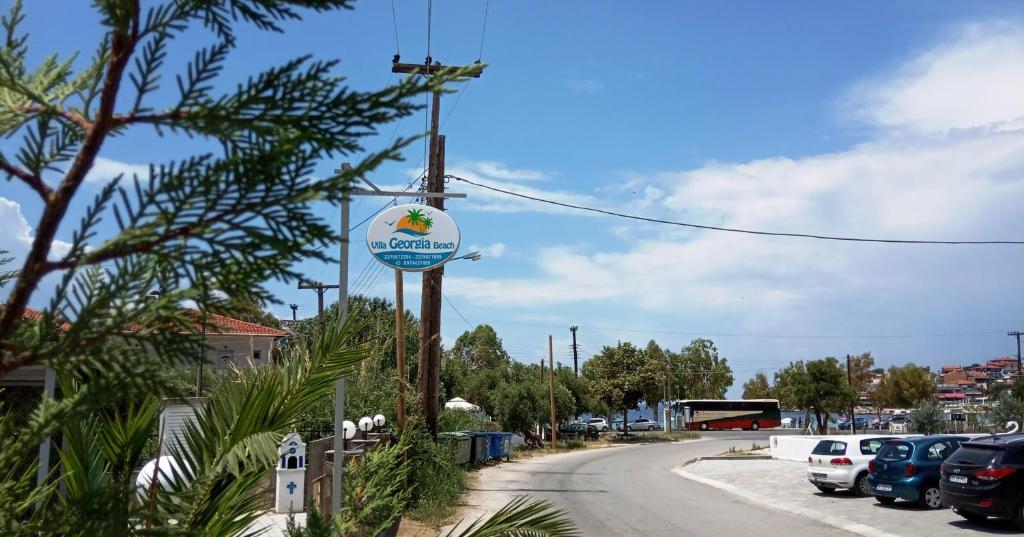 a sign on a pole next to a street at Villa Georgia beach in Neos Marmaras