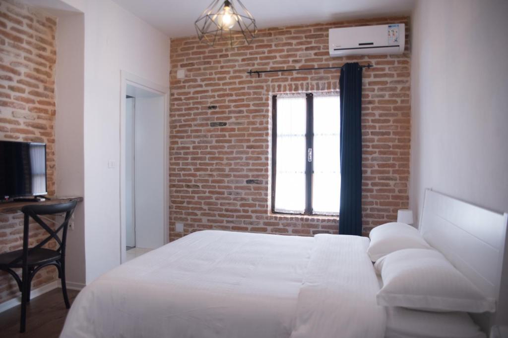Ένα ή περισσότερα κρεβάτια σε δωμάτιο στο Old Bazaar Rooms