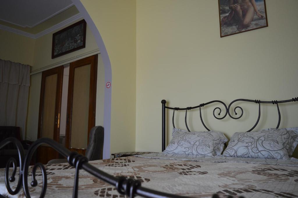 a bedroom with a bed with a metal frame at Anita's hosting in Kalamata