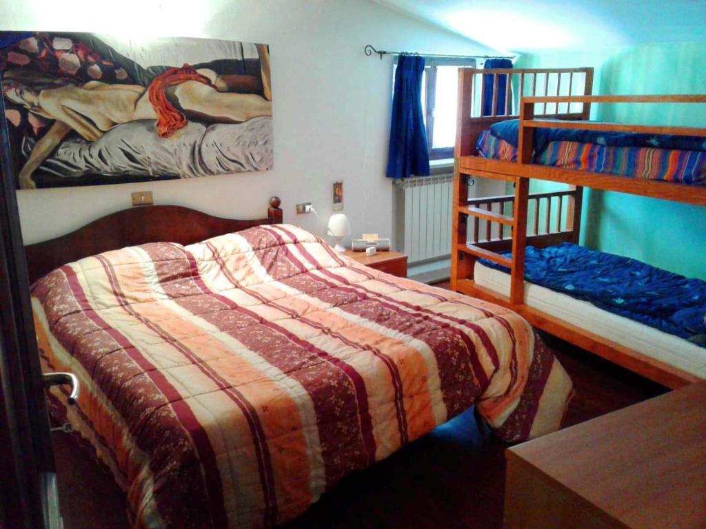 a bedroom with two bunk beds and a ladder at Casa Lombardi in Ovindoli