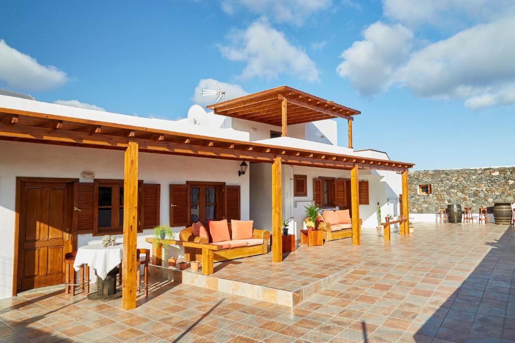 a house with a patio with furniture on it at Villa Nueva in Mala