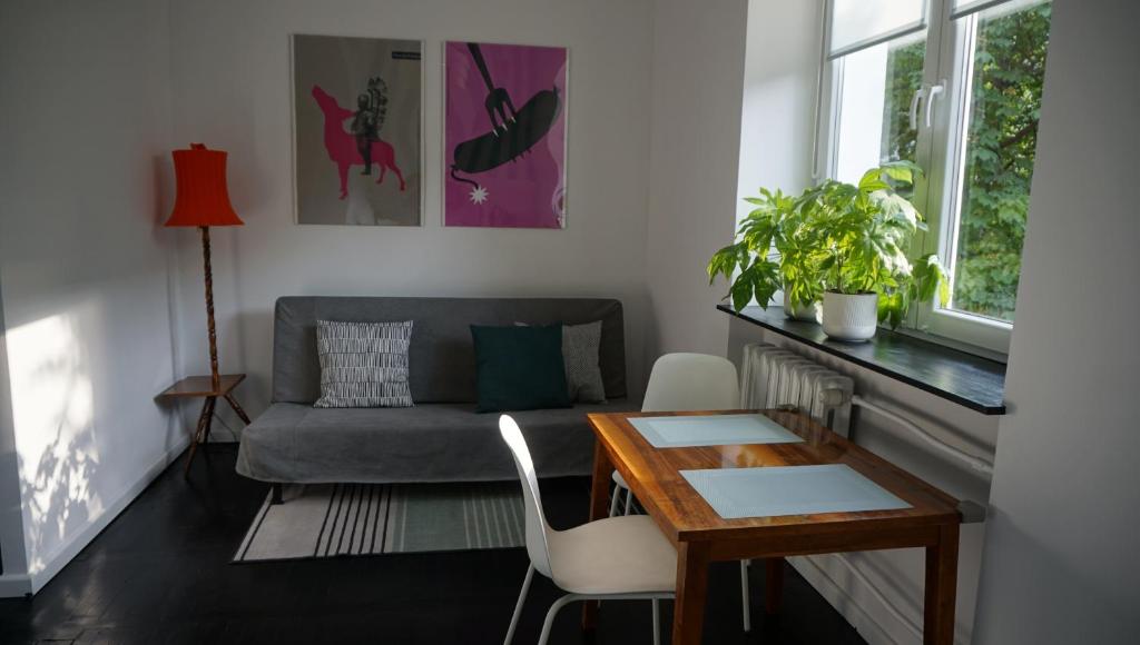 a living room with a couch and a table at Lovely Bubbly Apartment in Krakow