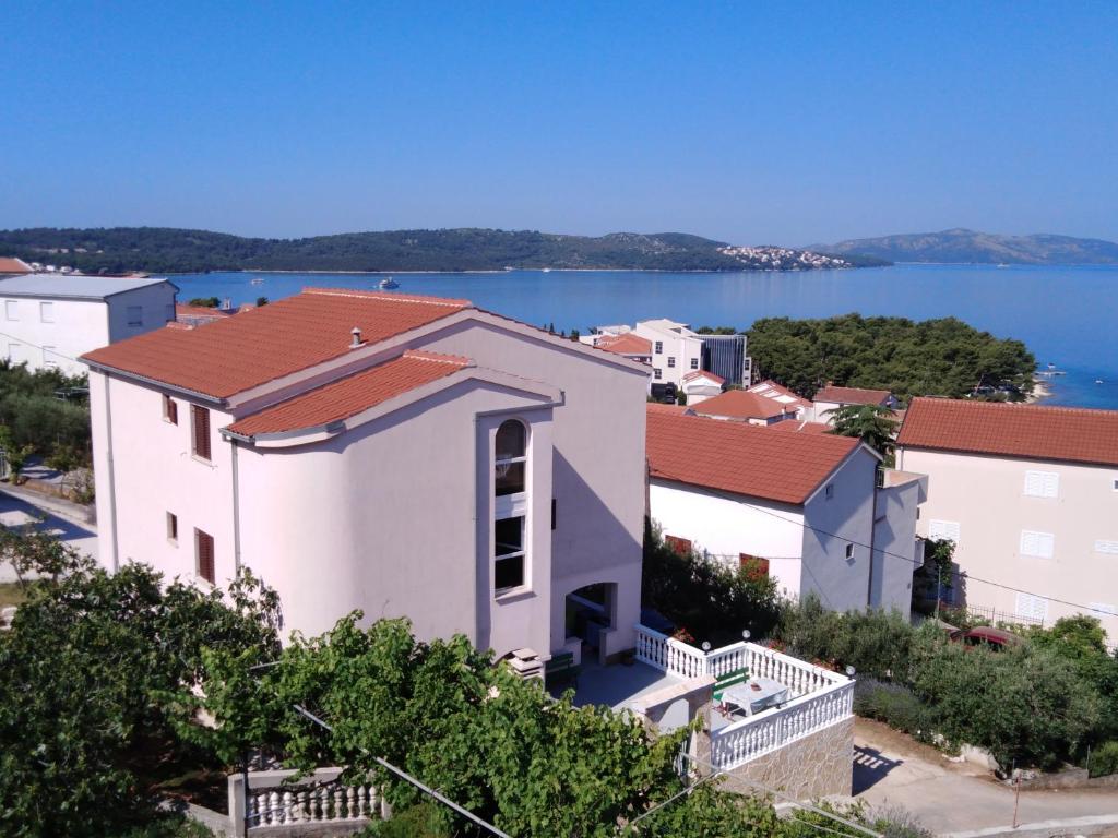 a white house with a view of the water at Apartments Gracia & Toni in Trogir