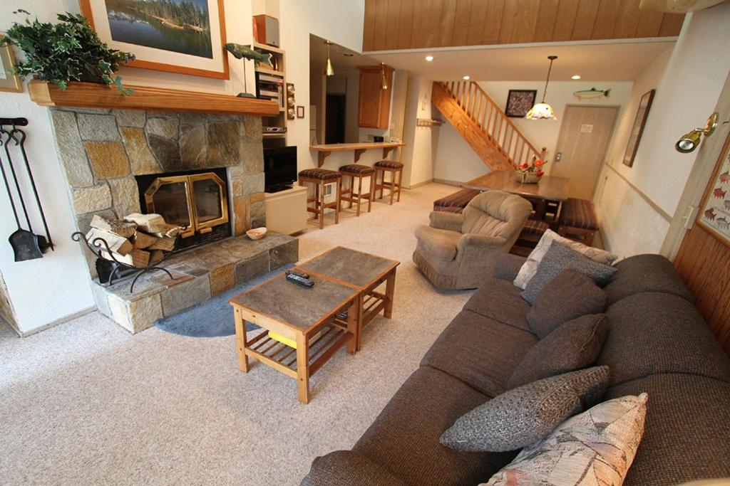 a living room with a couch and a fireplace at Mammoth Reservations in Mammoth Lakes