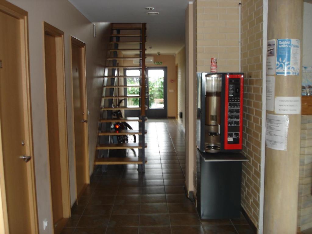 a hallway with a staircase leading to a room with a wine cellar at Aisa Accommodation in Pärnu