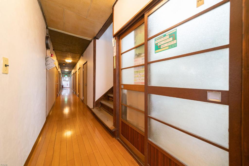 a hallway with a door in a building at Ryokan Nakadaya in Tokyo