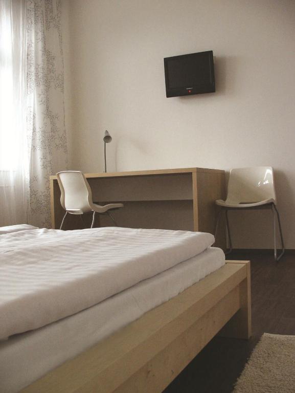 Postel nebo postele na pokoji v ubytování Hotel Saloon