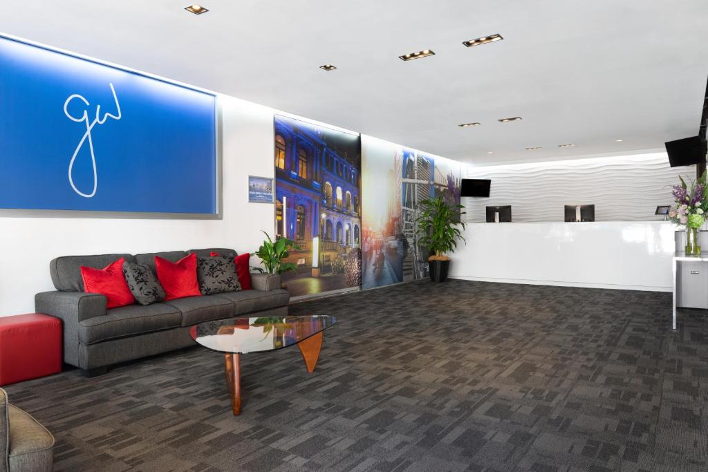 a living room with a couch and a table at George Williams Hotel in Brisbane