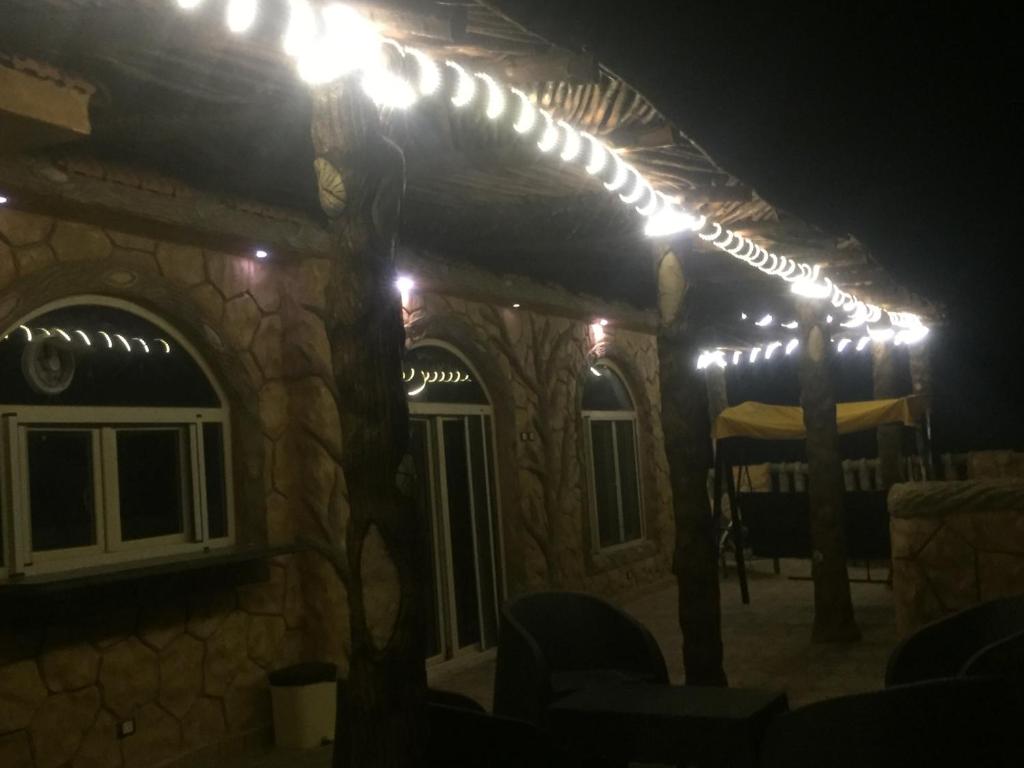 a group of lights on a house at night at Al-Madina Tower Apartments in Marsa Matruh