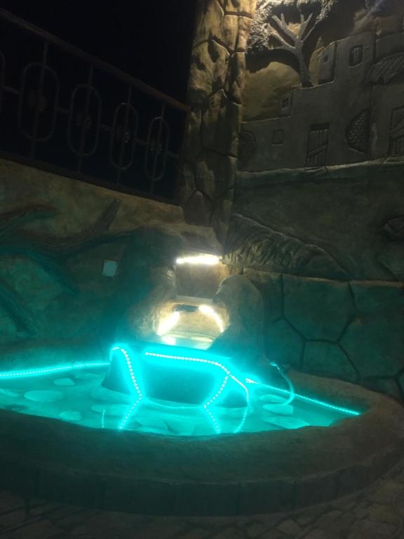 a hot tub lit up at night with lights at Al-Madina Tower Apartments in Marsa Matruh