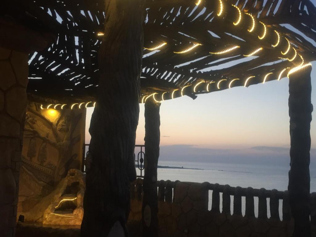 a view of the ocean from a building with lights at Al-Madina Tower Apartments in Marsa Matruh