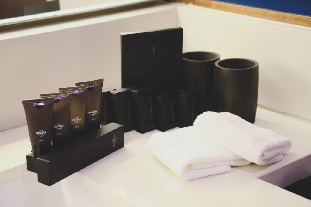 a pile of towels sitting on top of a counter at Hard Rock Hotel Desaru Coast in Desaru