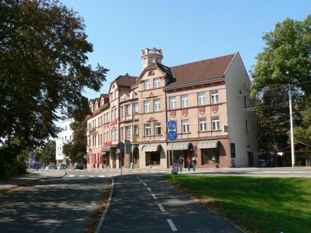 a large building on a street in a city at Hotel Saloon in Zlín