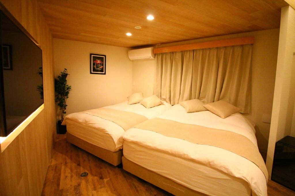 Postel nebo postele na pokoji v ubytování Sakura Cross Hotel Shinjuku East