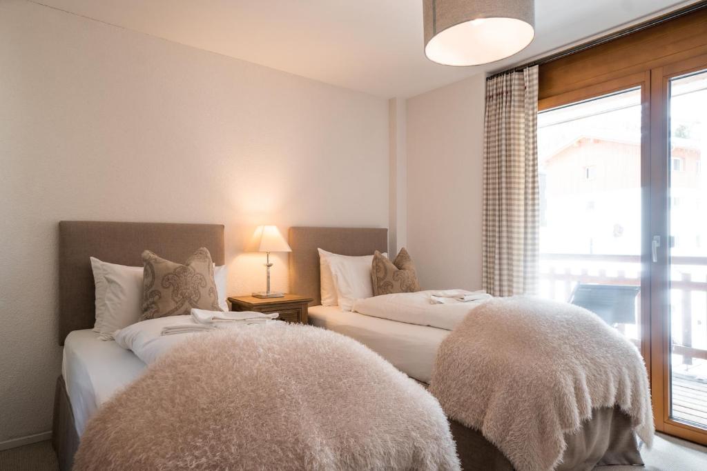 Postel nebo postele na pokoji v ubytování Sonnegg Lodge 2.1