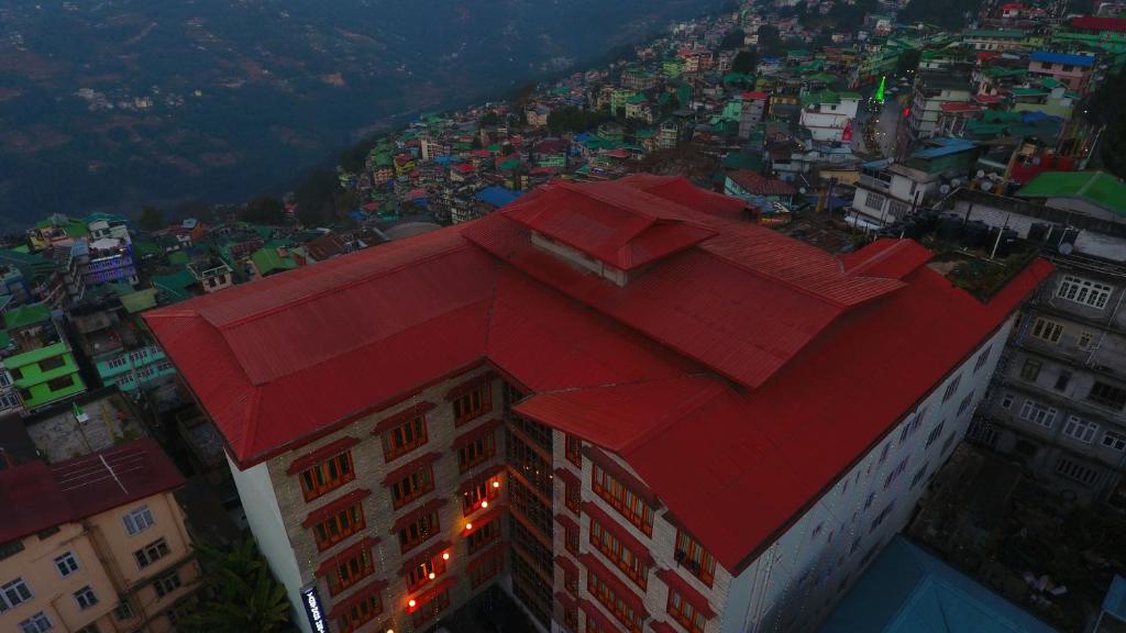 a red roof on a building in a city at Yangthang Heritage in Gangtok
