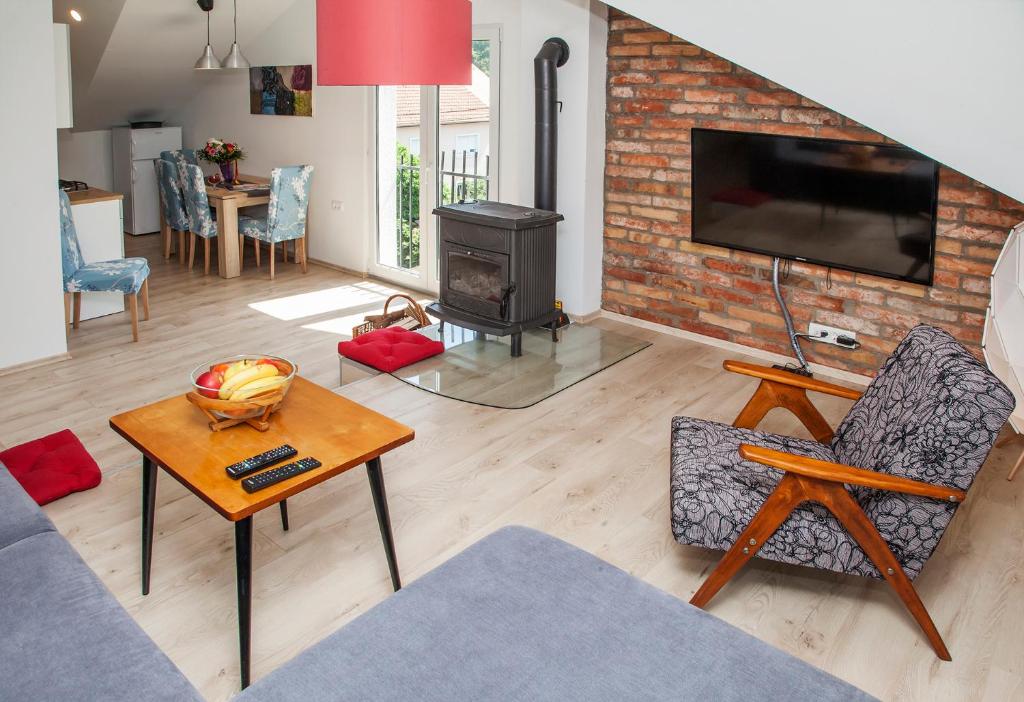 a living room with a fireplace and a tv at Apple tree in Zagreb