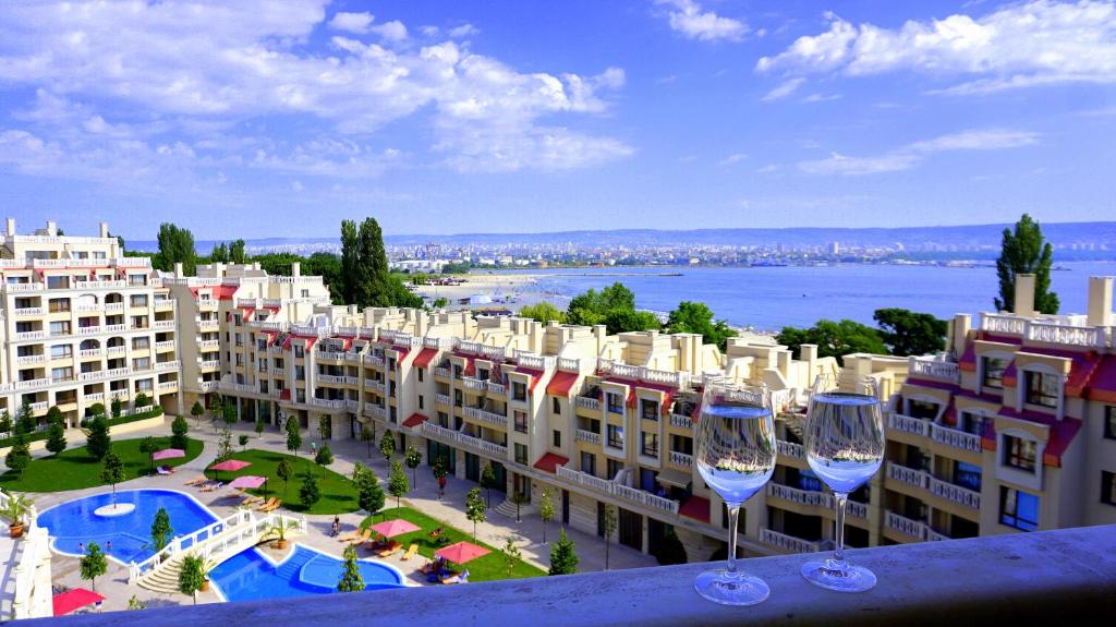 a view of a hotel with two wine glasses at Апартаменти Варна Саут на плажа - Varna South Apartments on the beach in Varna City