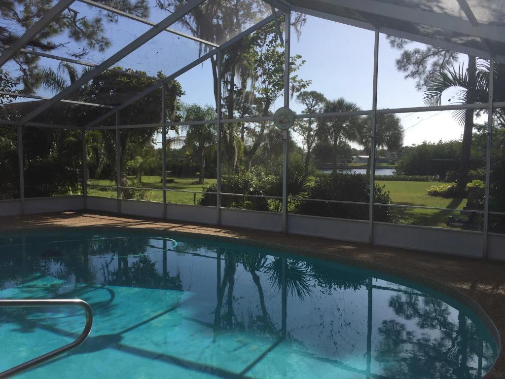 a swimming pool in a house with a view of the yard at Water FUN! poolPIERkayaksCANOE MotorBoatRENTALpets in Englewood
