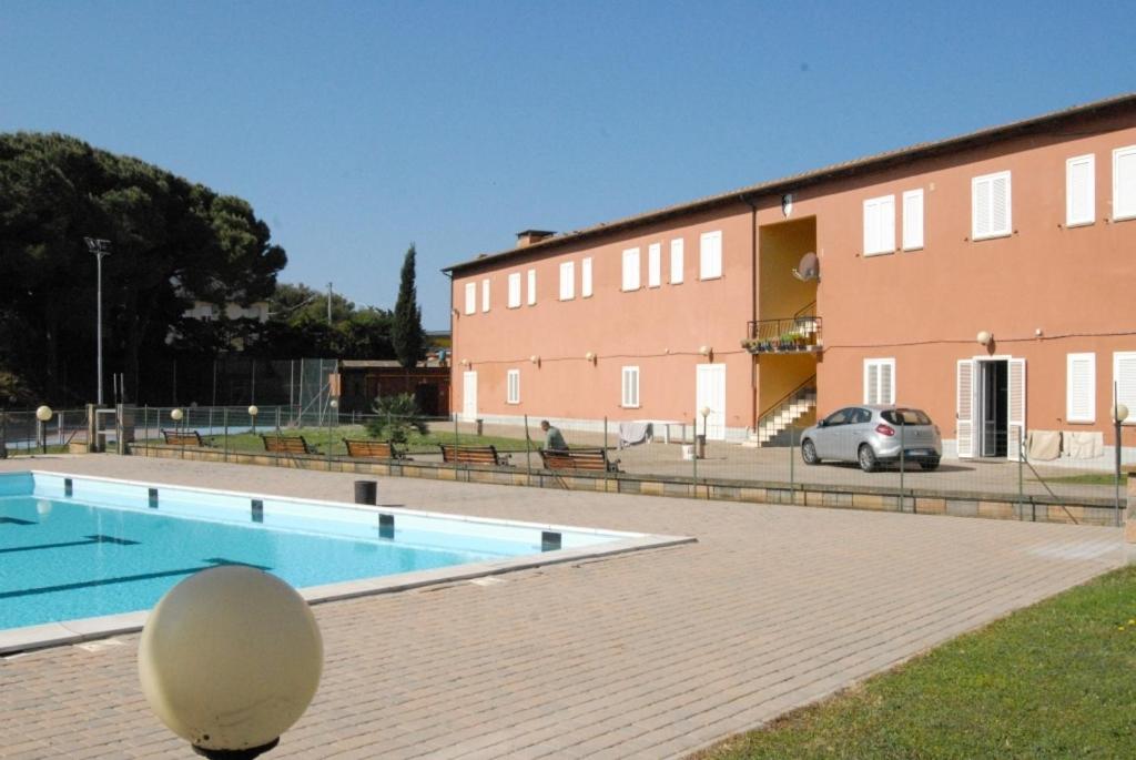 a large swimming pool in front of a building at Santa Caterina in San Vincenzo