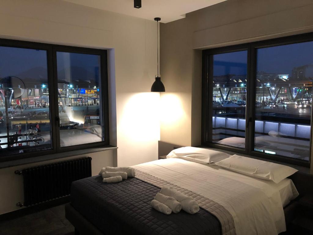 a bedroom with a bed with a view of a city at napoliurbansuite in Naples