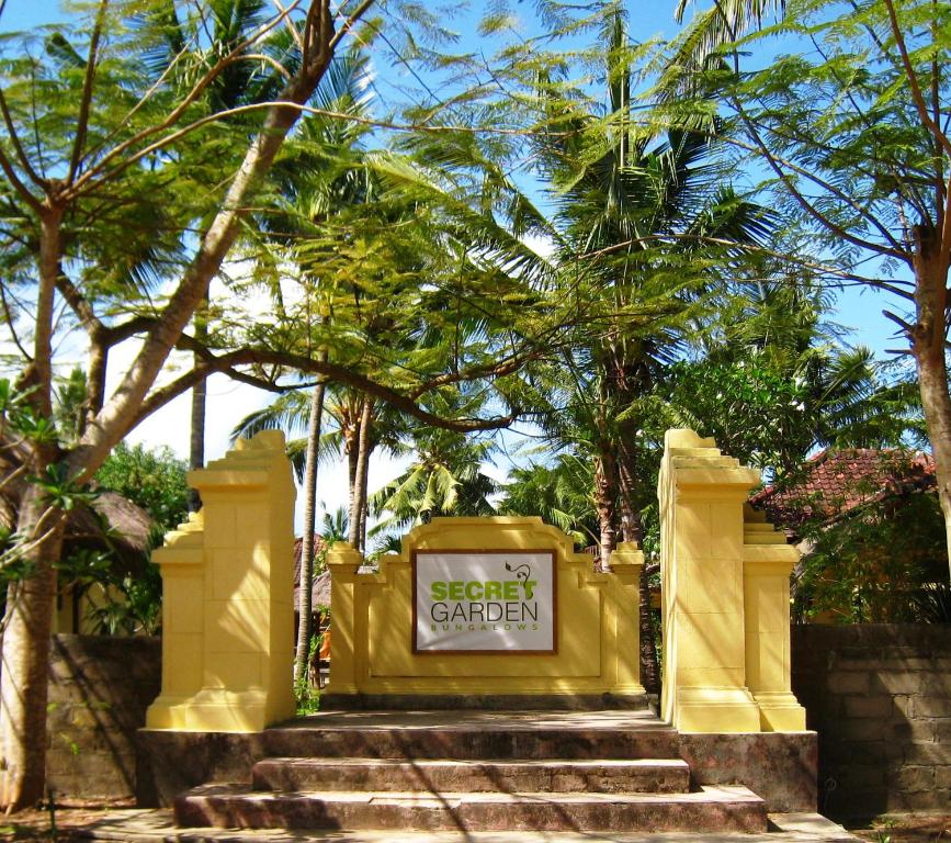 a sign for a secret garden on a set of stairs at Secret Garden Bungalows in Nusa Lembongan
