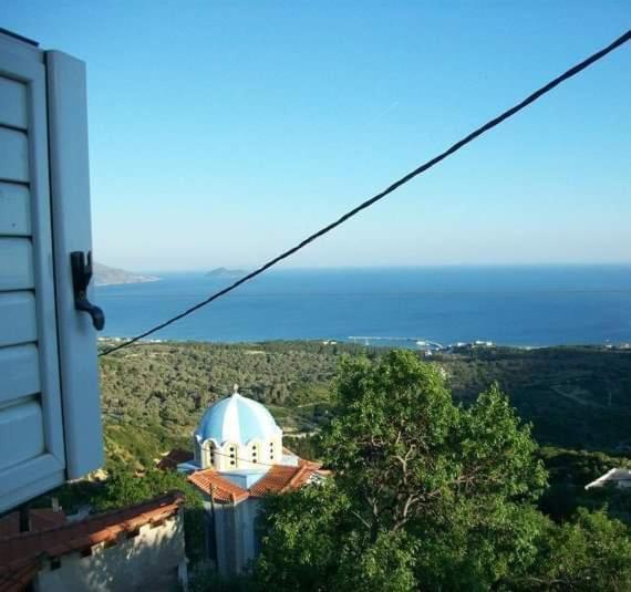 a view of a building with the ocean in the background at SAMOS 1880 in Marathokampos