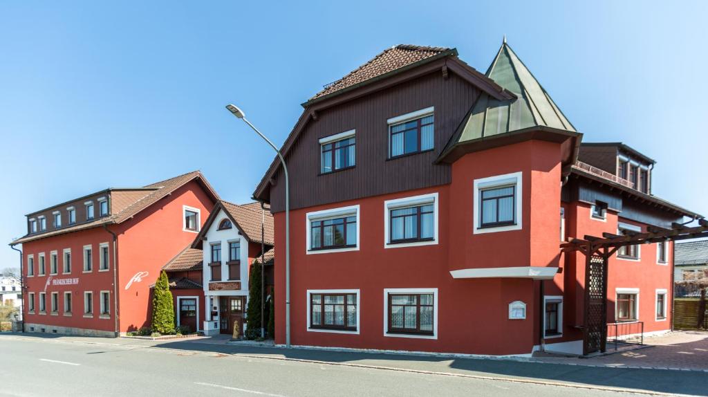 a red building on the side of a street at Fränkischer Hof in Rehau