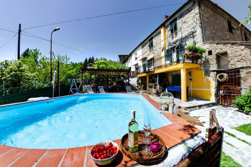 an outdoor swimming pool in front of a house at Casa Di Renzo in Lanciole