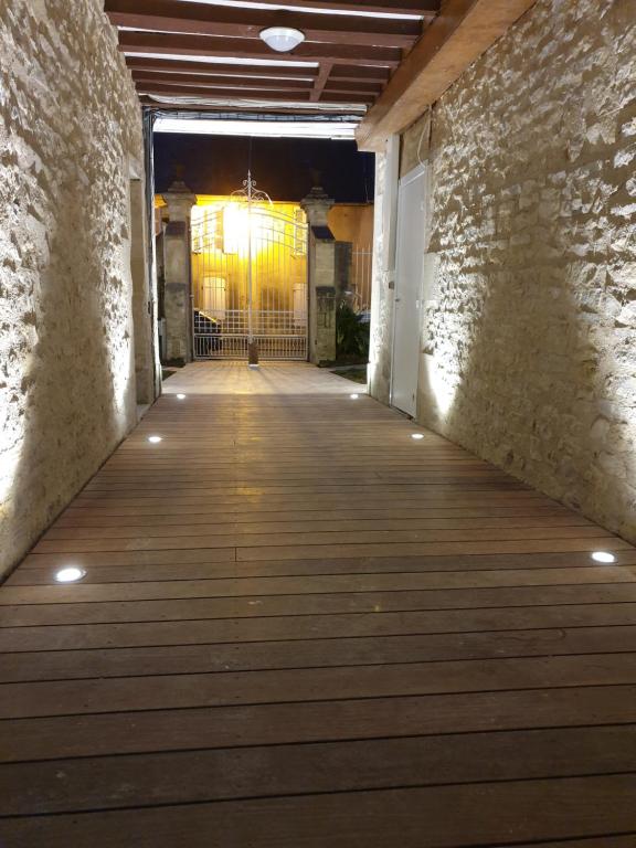 un pasillo con suelo de madera y un edificio en Au Loup Historic Apartments en Bayeux