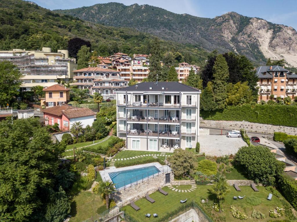 a large building with a swimming pool in a city at The View in Baveno