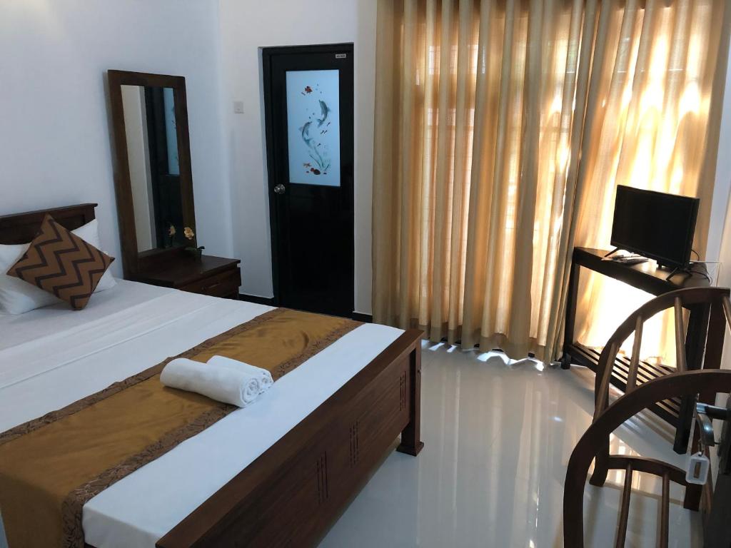 Postel nebo postele na pokoji v ubytování Kandyan Lounge