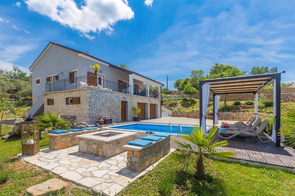 a villa with a swimming pool and a house at Villa Franolic in Bajčići