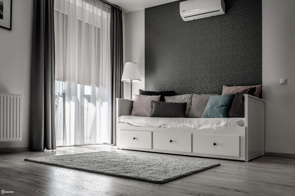 Postel nebo postele na pokoji v ubytování Aranymandula apartmanok