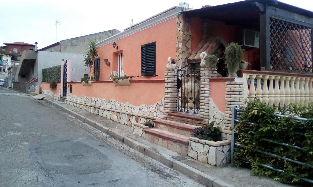 a house on the side of a street at la casa del glicine in Iglesias