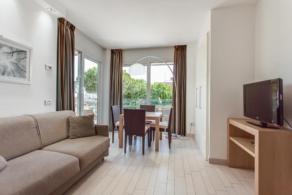 a living room with a couch and a dining room at Kontiki in Milano Marittima