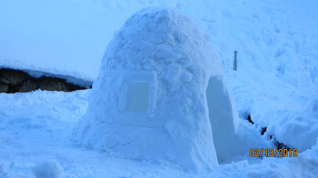 an ice house is covered in snow at Alpine Lodge 5 in Les Contamines-Montjoie