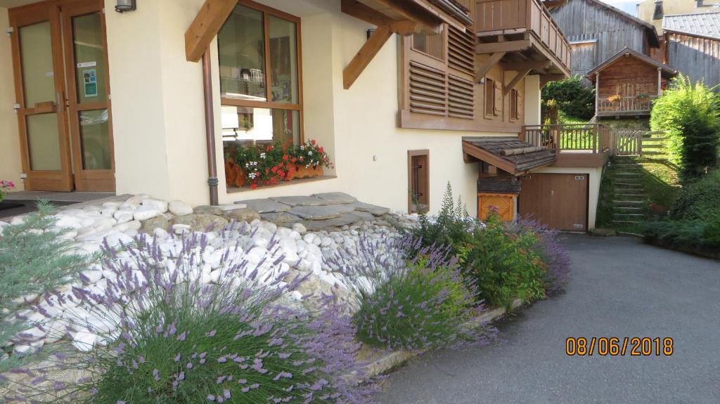a house with purple flowers in front of it at Alpine Lodge 5 in Les Contamines-Montjoie