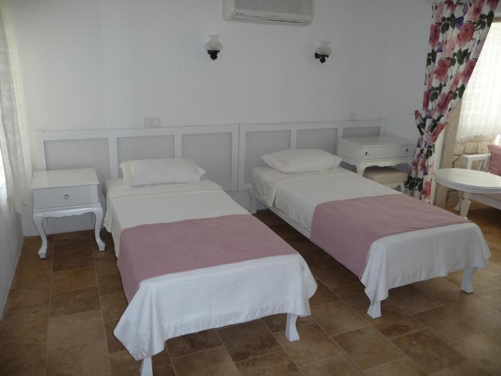 Postel nebo postele na pokoji v ubytování Yelken Konak Alacati