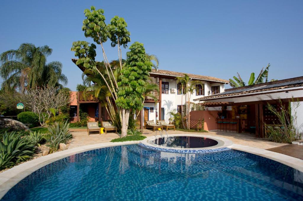 a swimming pool in front of a house at Pousada Vivenda in Tiradentes