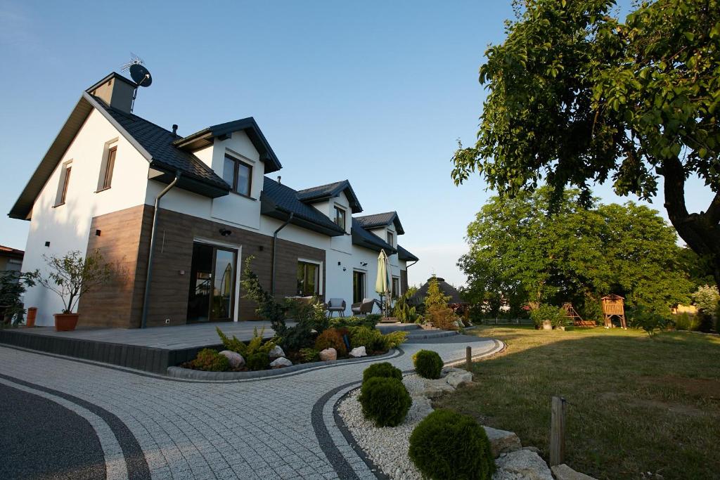 a house with a walkway in front of it at Siedlisko Vincent in Szydłów