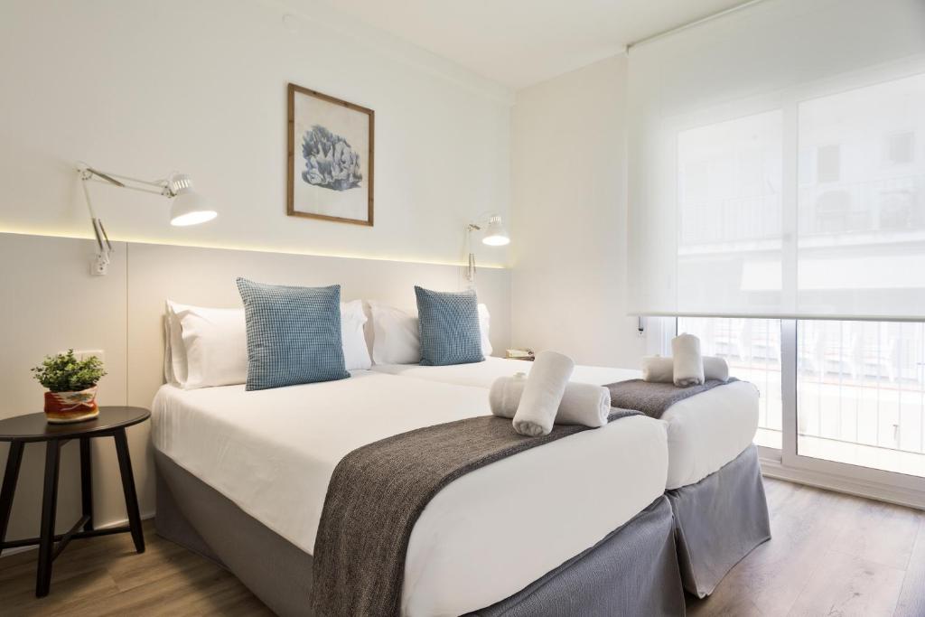 A bed or beds in a room at Sitges Group Calm Beach
