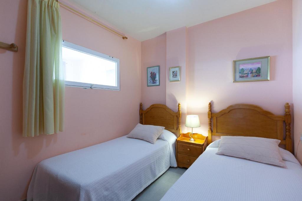 Posteľ alebo postele v izbe v ubytovaní UHC Sorolla Apartments