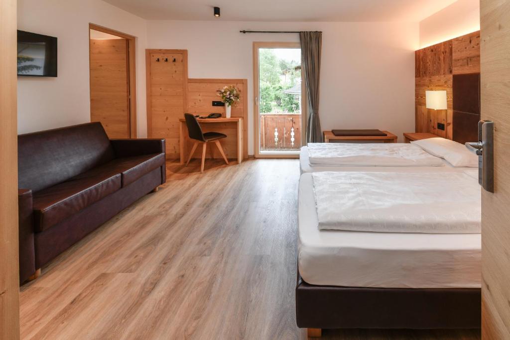 Postel nebo postele na pokoji v ubytování Hotel Brunella