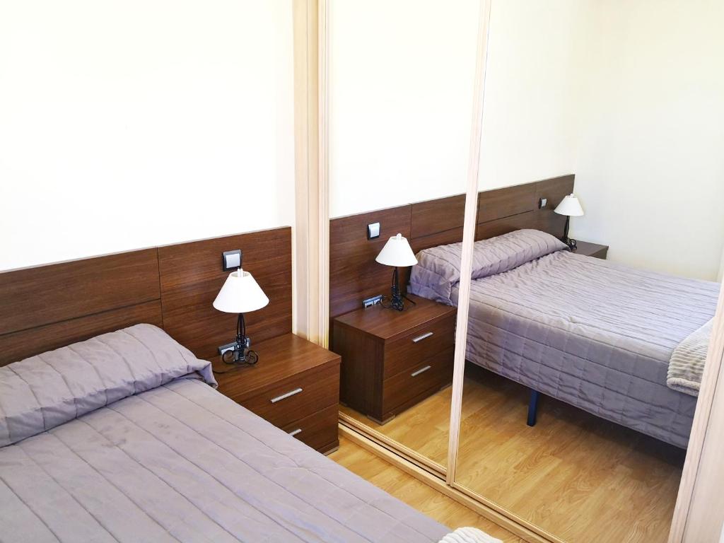 Cama o camas de una habitación en Apartamentos Cocó