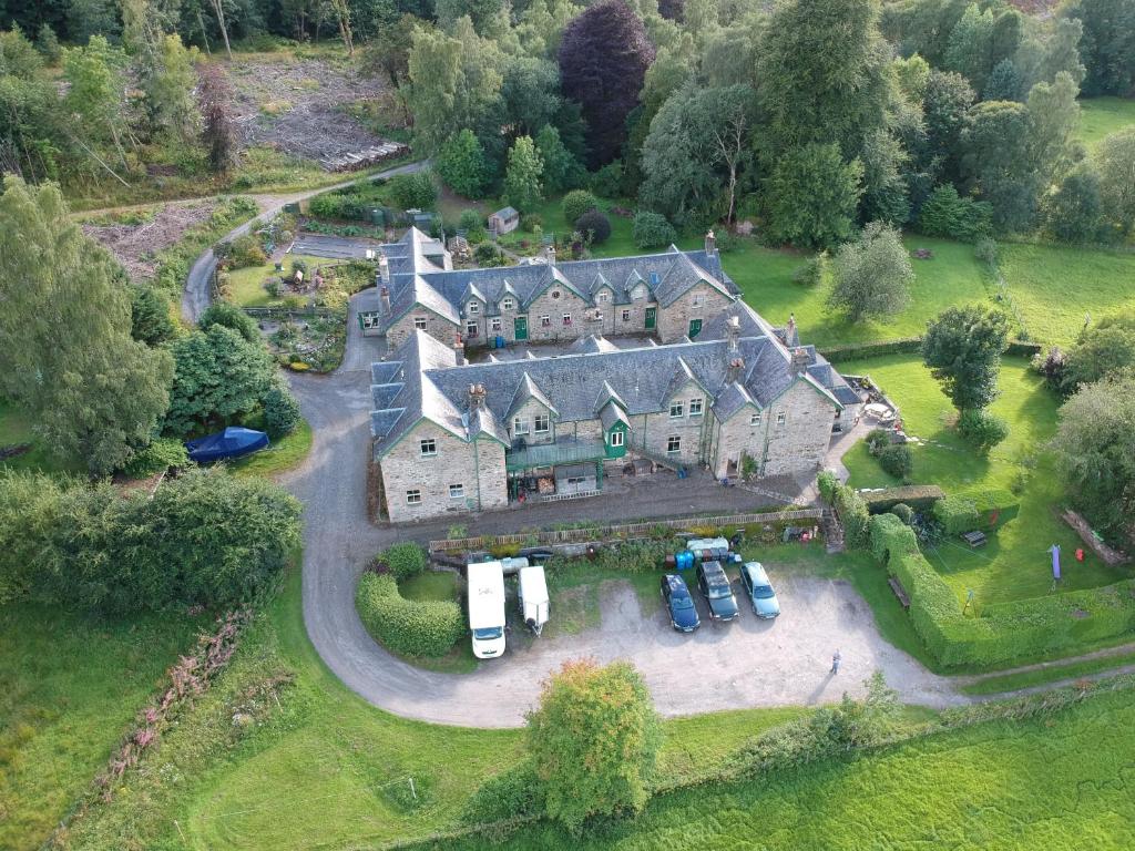 an aerial view of a large house with parked cars at Auchmore Apartments in Killin