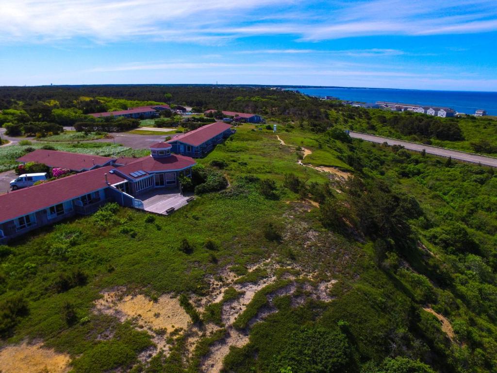 an aerial view of a house with the ocean in the background at Dune Crest Hotel in North Truro