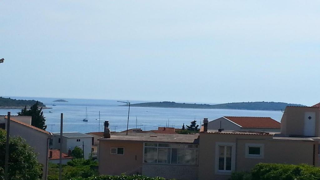 a view of the water from a city with houses at Apartment M&M in Primošten